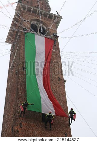 Vicenza, Vi, Italy - December 4, 2015: Firefighters With A Big Italian Flag