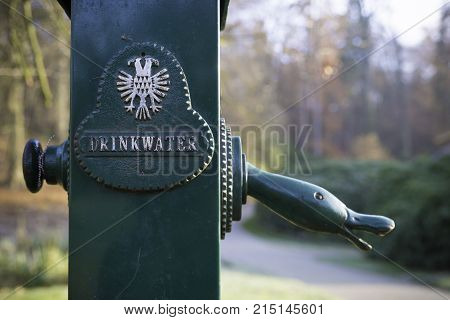 green drinkwater (drinking water) tap in a dutch park