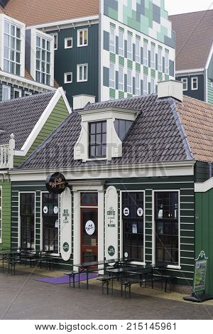 ZAANSTAD NETHERLANDS - NOVEMBER 13 2016: Typical old dutch green wooden facade of a shop next to the Inntel hotel