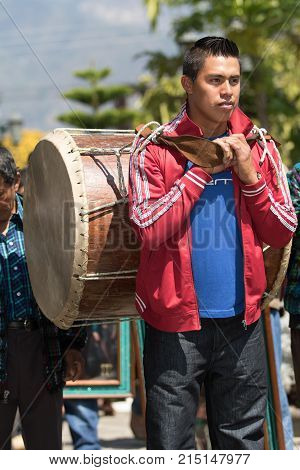 March 24, 2016 San Pedro la Laguna, Guatemala: young mayan man carries a traditional drum on its back during Easter Week celebration