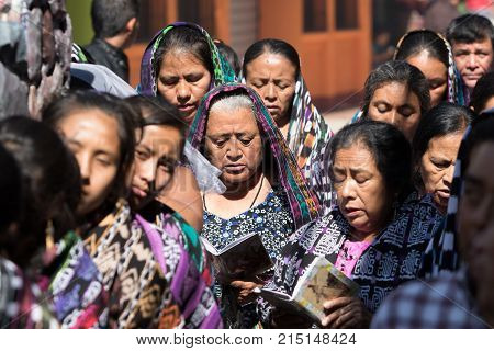 March 25, 2016 San Pedro la Laguna, Guatemala: women float carriers wearing traditional Mayan dress during Easter Week celebration