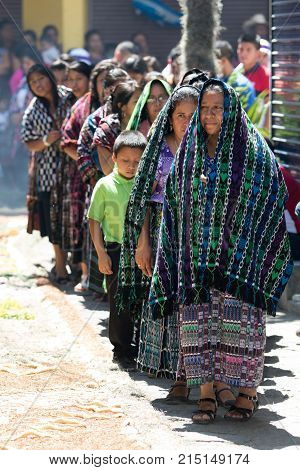 March 25,2016 San Pedro la Laguna, Guatemala: tzutujil mayan women walking in traditional dress during Easter Week celebration