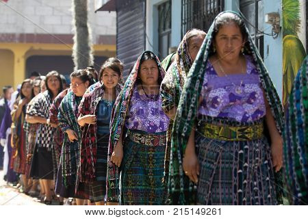 March 25,2016 San Pedro la Laguna, Guatemala: tzutujil mayan women walking in traditional dress during Easter Week celebration