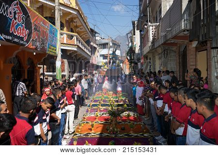 March 25, 2016 San Pedro la Laguna, Guatemala: the Easter procession is advancing on the top of colorful ground cover on the street of the Mayan town