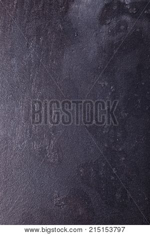 Close-up of an old black background. Grunge texture. Dark wallpaper. Free space for text.