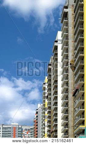Facade of new colorful modern residential building side view on sunny day close-up
