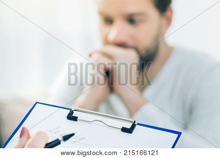 Depression symptoms. Selective focus of a psychologists notes taken during a psychological session