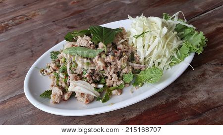 spicy laab thai pork salad with fresh vegetable