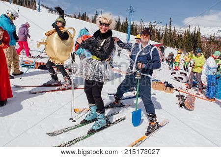 Sheregesh, Kemerovo region, Russia - April 22, 2017: Grelka Fest is a sports and entertainment activity for ski and snowboard riders in carnival costume. Woman on ski in carnival costume of dragonfly.