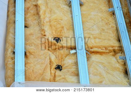 Exterior house wall heat insulation with mineral wool closeup, unfinished result of installing insulate panels