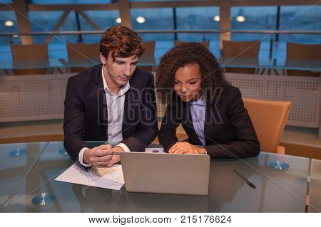 Business people having meeting around table in modern office.