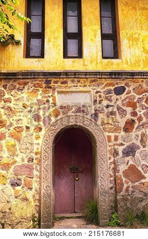 A stone building exterior and arched doorway on Lake Tai and Taihu in Wuxi China in Jiangsu Province.