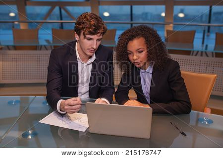 Business people having meeting around table in modern office.