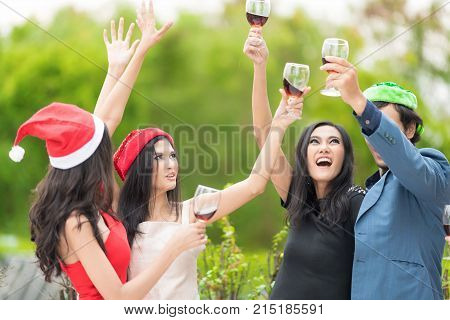 Funny People celebrating happy drinks with friends.Red wine Christmas party concept. Happy new year coming soon.Cheers.