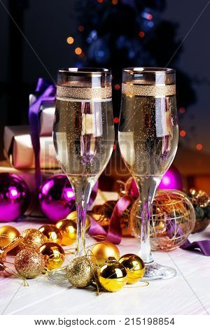 Champagne and Gifts.New Year Celebration. Christmas decorations with wineglass. toasting with champagne glasses