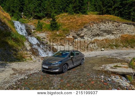 KHULO, GEORGIA - 08 AUGUST 2017: Car in water of the mountain waterfall near Khulo village of Georgian Adjara region