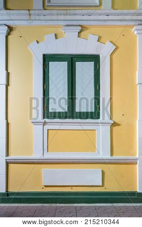 Europian style window on yellow and white wall. Vintage style wondow.