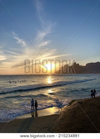 Nice sunset view in the beach and some people in shadow