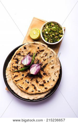 Bajra roti or Jowar Roti or Indian bread made using Bajra or Jowar, served with green chilly thecha