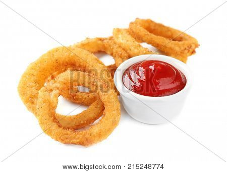 Fried breaded onion rings with ketchup on white background