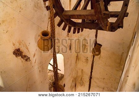 Close up wooden wheel part of watre supply system in historical Amer Fort in India