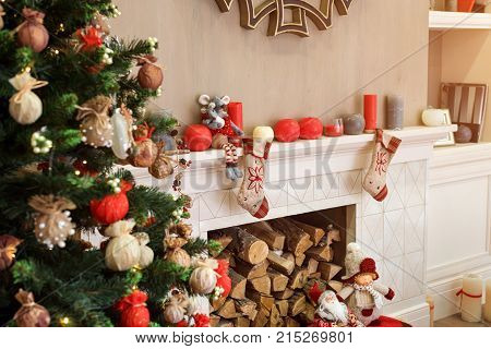 Cozyness And Home Comfort. Decorated Christmas Tree And Fireplace With Firewood. Winter Holidays Roo