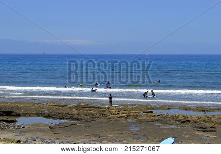 Playa De Las Americas beach Tenerife Canary Islands Spain Europe - June 12 2016 : Surfing on Playa De Las Americas beach