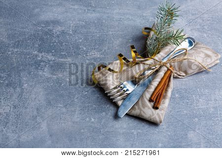 Creatively serving tablewares are decorated with a Christmas tree and cinnamon sticks. Christmas atmosphere. View from above. Indoors.