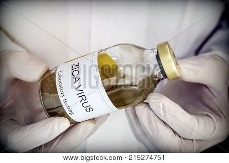 Doctor holds vial. Tests for Research of ZIKA test, image conceptual