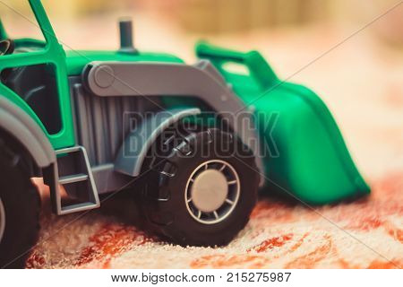 a toy tractor in the nursery in bed