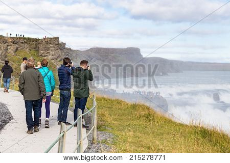 Tourists Take Photo Of Gullfoss Waterfall