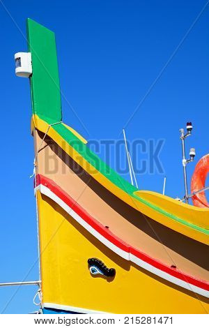 The front of a traditional Maltese Dghajsa fishing boat Mellieha Malta Europe.