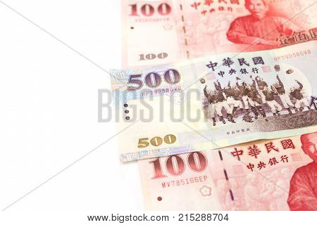 Pile of various Taiwan money isolated on white background. Close up new one and five hundred Taiwan dollar bills for money background.