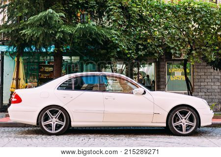 Batumi, Adjara, Georgia - September 7, 2017: Car brand Mercedes-Benz E 320 is parked on a narrow street in the old part of city