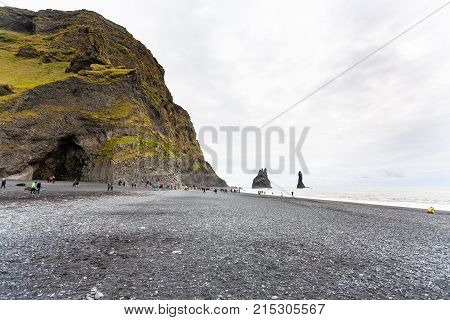 Tourists Near Halsanefshellir Cave On Beach