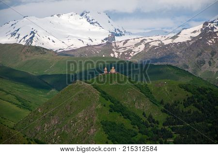 Holy Trinity Church in Georgia. Under Mount Kazbegi. Spring Or Summer Season.