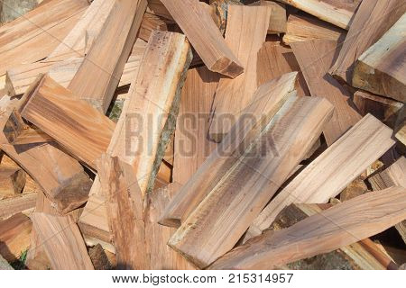 Firewood background - chopped firewood on a stack. Dry chopped firewood logs in a pile. pile of split firewood fuel material