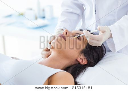 Beautiful Young Woman Getting Botox Cosmetic Injection In Her Face.