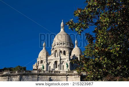 The basilica Sacre Coeur is a Roman catholic church located at the summet of the butte Montmartre , the highest point in Paris.