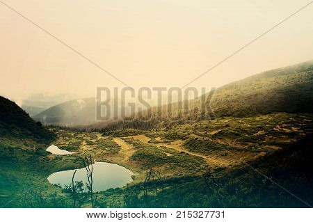Two lakes in the Carpathians with forest and mountains around