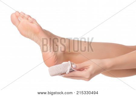Female feet heel stone pumice on white background isolation