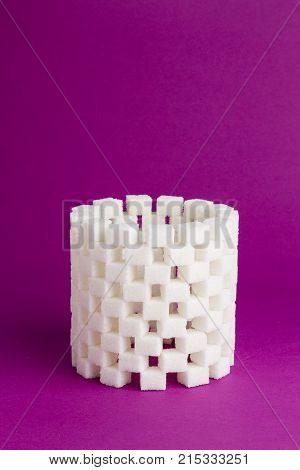 hight tower of refined sugar on a pink background