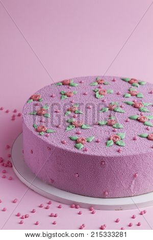 pink velvet cake with roses and leaves on a pink background
