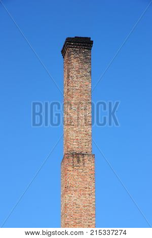 One Orange Brick Pipe On Blue Sky.