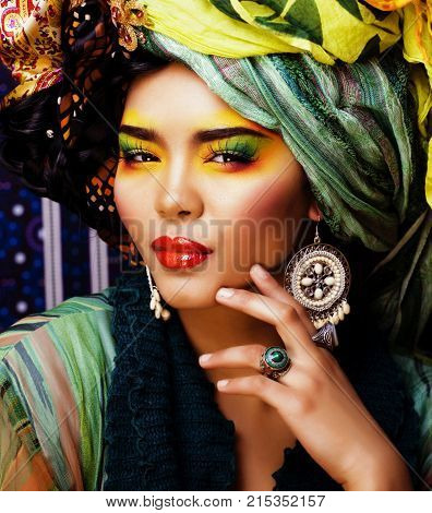 beauty bright woman with creative make up, many shawls on head like cubian, ethno look