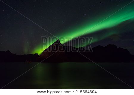 Northern lights over Olstind mountain Lofoten Norway