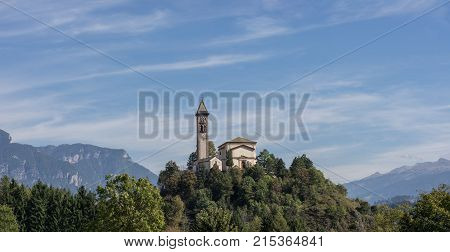 Castle on the hill landscape mountains and peaks in background. Trentino South Tirol Castello Molina Di Fiemme Alto Adige Italy - Saint George Church