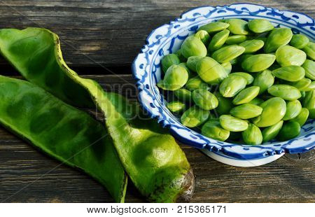 Parkia speciosa or English name is bitter bean on wooden background