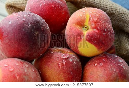 Many Fresh Peach with water drops and shadow on wooden background