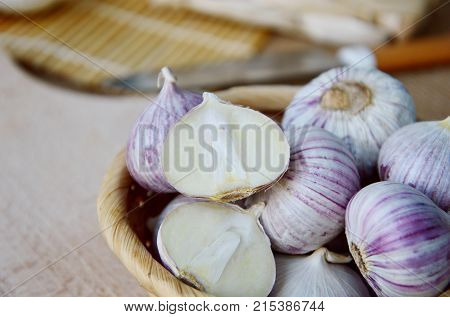 Solo garlic or single clove garlic in basket on sack background